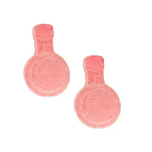 A pair of Dungeon and Dragons D&D DND D20 +1 Potion Sour Candy Collectible Tin - One (1) Tin - Sour Cherry Flavor soap bubbles on a white surface.