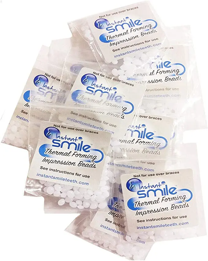 A pack of 12 Packages of Instant Smile Billy Bob Replacement Thermal Adhesive Fitting Beads for Fake Teeth in a plastic bag.