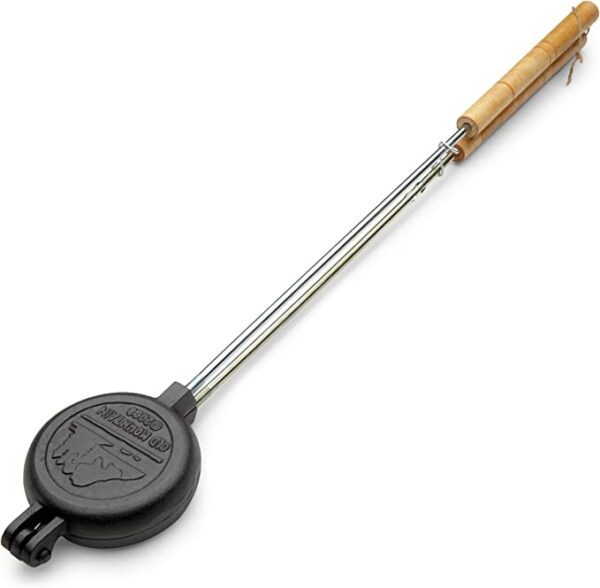 A Old Mountain Pre Seasoned Round Pie Iron, 28 Inch Long with a handle on a white background.