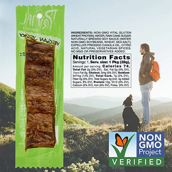 A dog is standing on a hill with a bag of Primal Spirit Vegan Jerky – “Classic Flavor” – Mesquite Lime, 10 g. Plant Based Protein, Certified Non-GMO, No Preservatives, Sports Friendly Packaging (24 Pack, 1 oz) dog food.