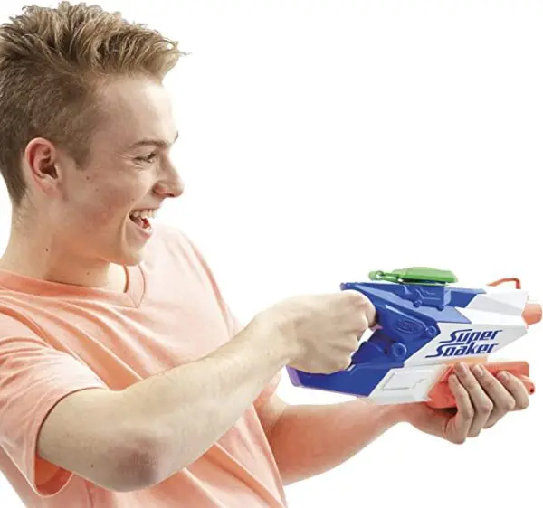 A young man playing with a Nerf Super Soaker FreezeFire 2.0.