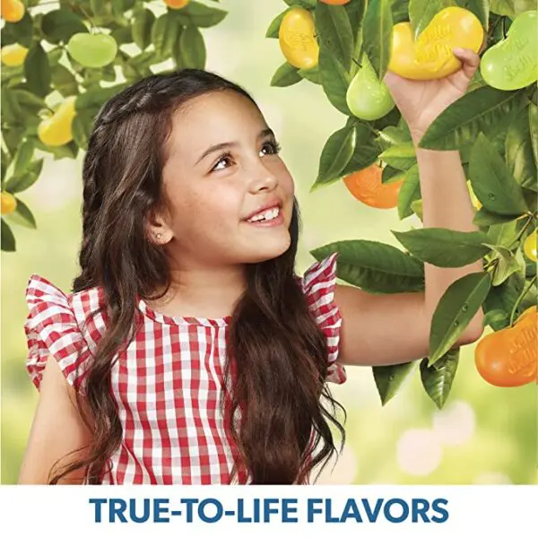 A girl is picking Sugar-Free Jelly Belly Jelly Beans - Genuine, Official, Straight from the Source, 2.8 Ounce (Pack of 12) from a tree.