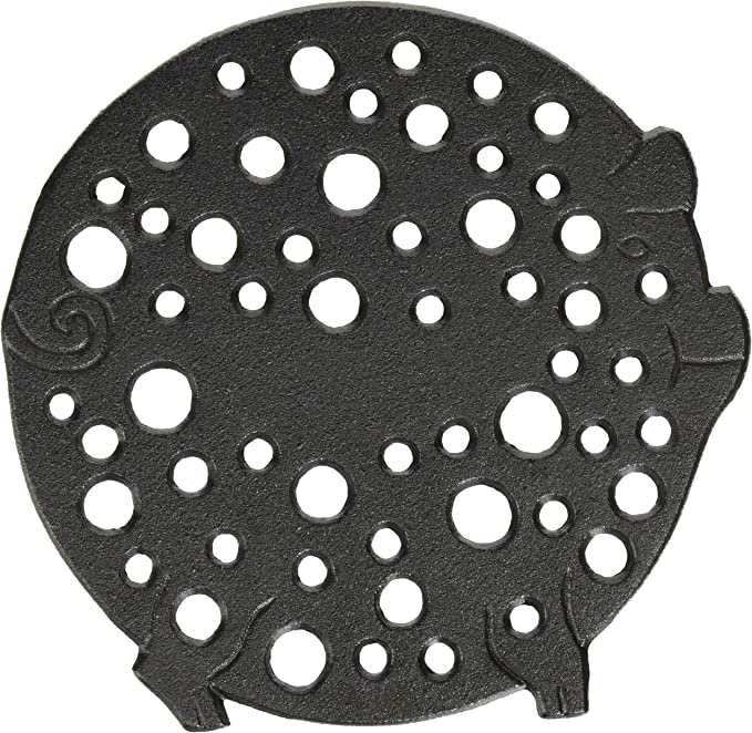 An Old Mountain Cast Iron Pig Trivet with holes on it.